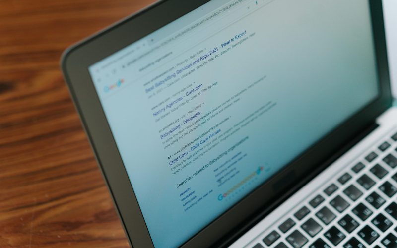 A close-up view of a laptop displaying a search engine page.