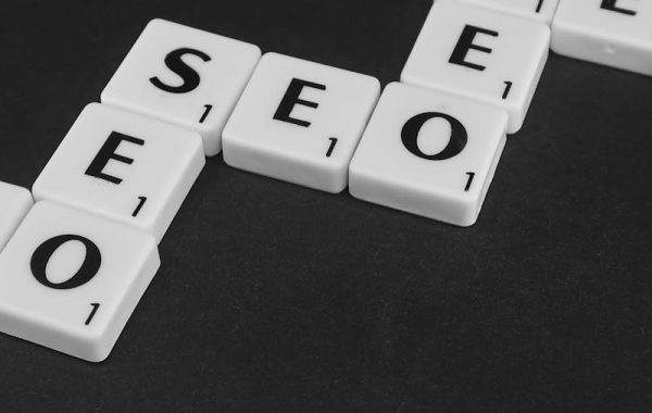 SEO spelled with Scrabble tiles on a black surface, representing search engine optimization concepts. and seo for small businesses